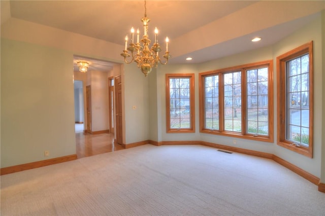 carpeted spare room with a healthy amount of sunlight, baseboards, visible vents, and recessed lighting