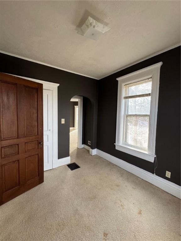 unfurnished bedroom featuring light carpet