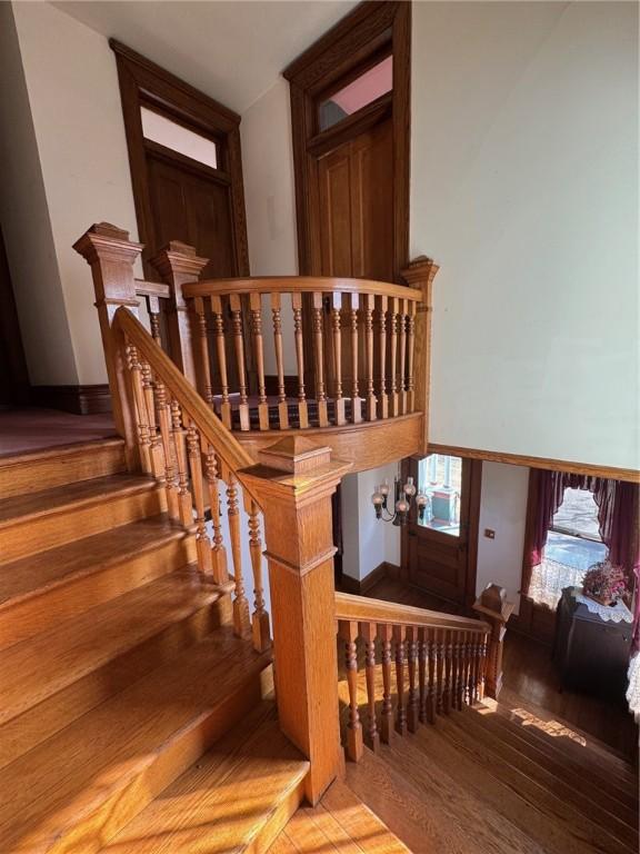 staircase with hardwood / wood-style flooring