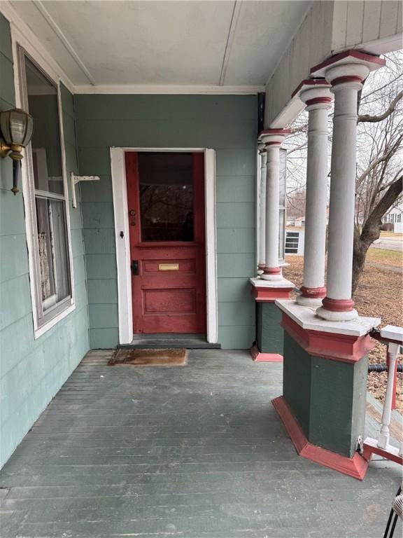 view of exterior entry with covered porch