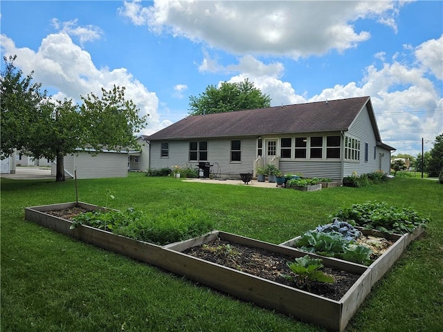 504 W Walnut St, Teutopolis, IL 62467 - back of property featuring a vegetable garden, a lawn, and a shingled roof