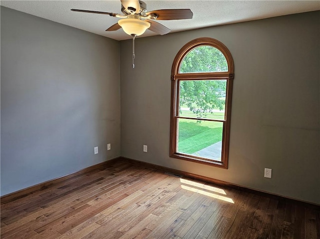 504 W Walnut St, Teutopolis, IL 62467 - unfurnished room featuring wood finished floors, ceiling fan, and a textured ceiling