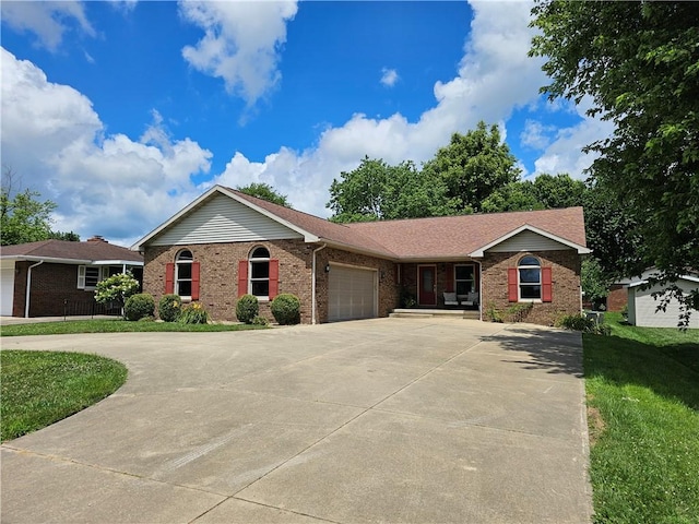 504 W Walnut St, Teutopolis, IL 62467 - single story home featuring brick siding, a garage, driveway, and a front yard