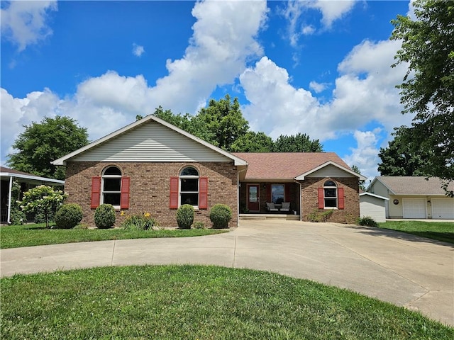 504 W Walnut St, Teutopolis, IL 62467 - ranch-style house with brick siding, curved driveway, and a front lawn