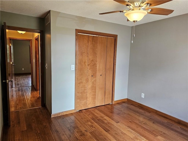 504 W Walnut St, Teutopolis, IL 62467 - unfurnished bedroom with wood finished floors, a closet, and a ceiling fan