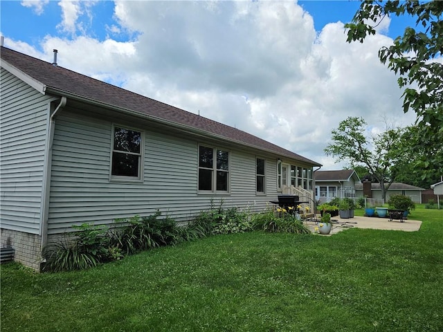 504 W Walnut St, Teutopolis, IL 62467 - back of house with a patio area, a lawn, and a shingled roof