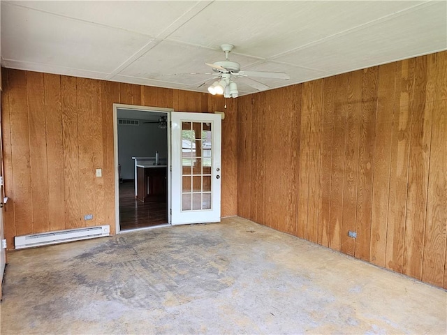 504 W Walnut St, Teutopolis, IL 62467 - empty room with a baseboard radiator, wooden walls, unfinished concrete floors, and a ceiling fan