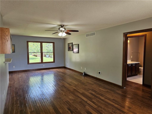 504 W Walnut St, Teutopolis, IL 62467 - unfurnished living room with a ceiling fan, wood finished floors, and a textured ceiling