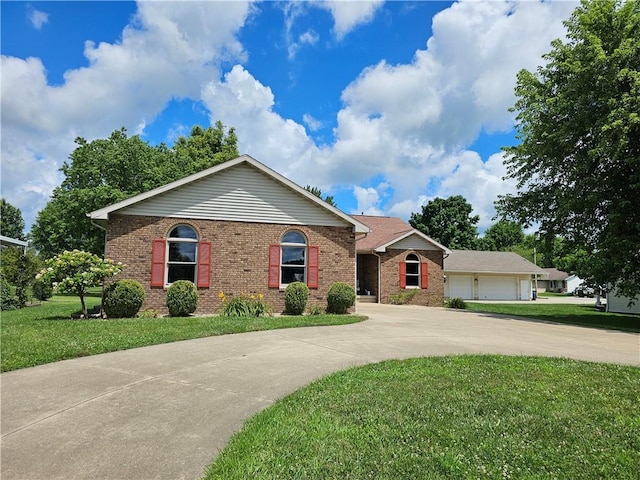 504 W Walnut St, Teutopolis, IL 62467 - ranch-style house featuring curved driveway, brick siding, and a front lawn