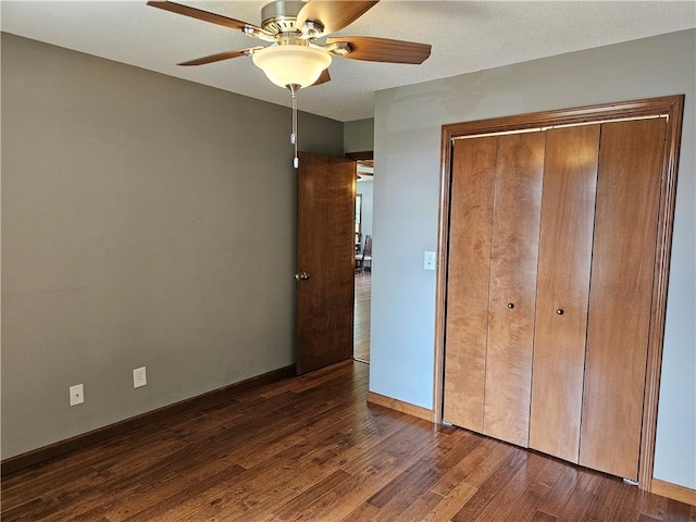 504 W Walnut St, Teutopolis, IL 62467 - unfurnished bedroom with dark wood-style floors, a closet, and ceiling fan