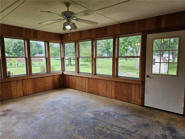 504 W Walnut St, Teutopolis, IL 62467 - unfurnished sunroom featuring healthy amount of natural light, unfinished concrete flooring, and wooden walls