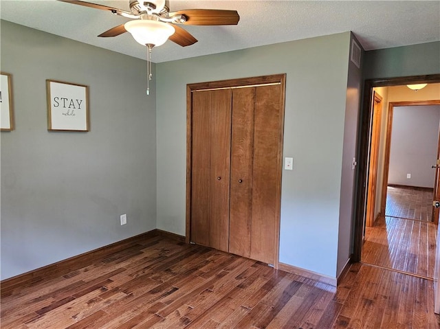504 W Walnut St, Teutopolis, IL 62467 - unfurnished bedroom with wood finished floors, a closet, and ceiling fan