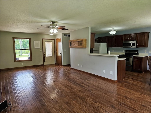 504 W Walnut St, Teutopolis, IL 62467 - kitchen with appliances with stainless steel finishes, light countertops, a peninsula, a textured ceiling, and ceiling fan