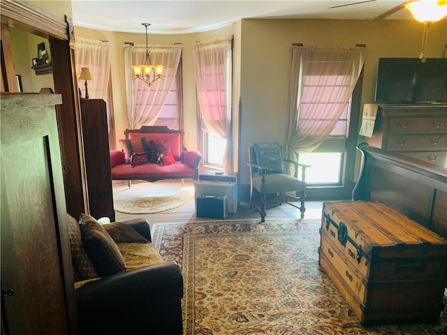 living area featuring wood finished floors and a notable chandelier