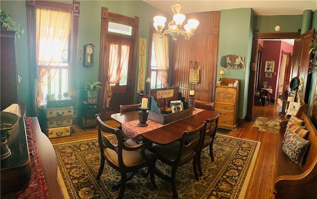 dining space featuring a chandelier and wood finished floors