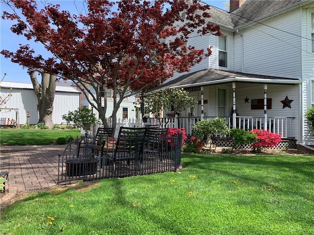 view of yard with a patio and covered porch