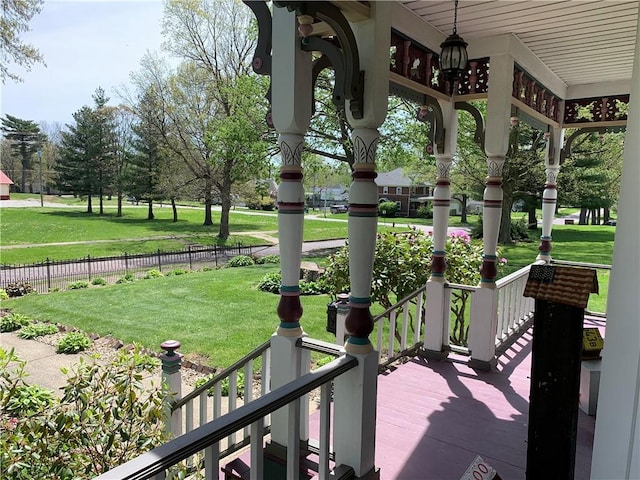 view of property's community featuring fence and a yard