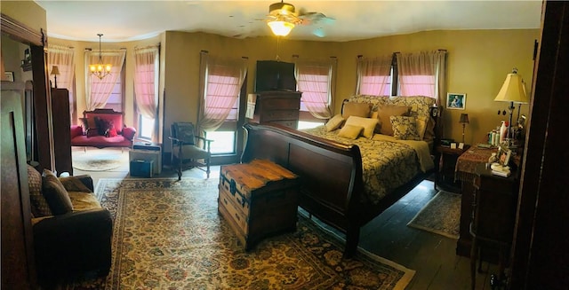 bedroom featuring wood finished floors and a notable chandelier