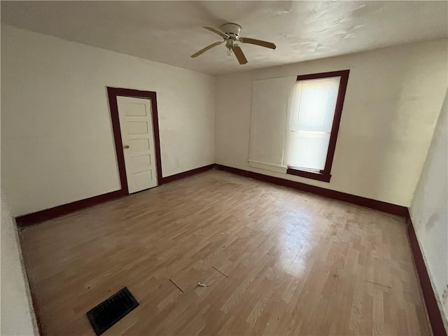 unfurnished room featuring light hardwood / wood-style flooring and ceiling fan