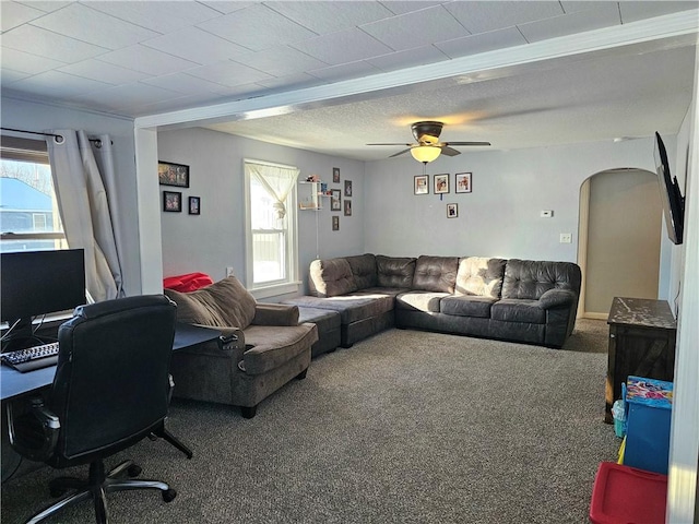 carpeted living room featuring ceiling fan and plenty of natural light