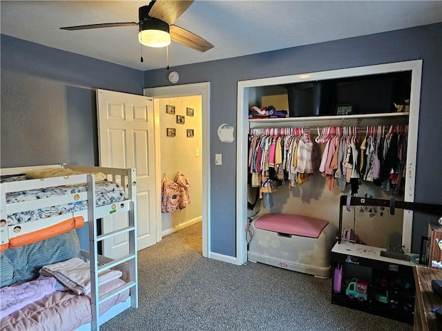 carpeted bedroom with ceiling fan and a closet