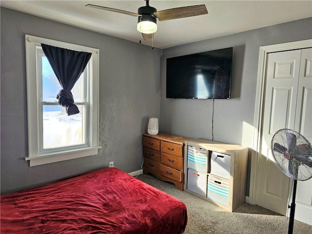 carpeted bedroom featuring ceiling fan