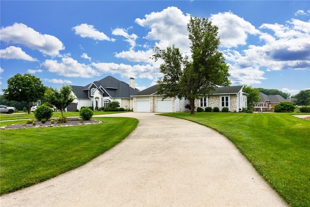 11311 E Thistlewood Ln, Effingham, IL 62401 - view of front of property featuring an attached garage, a front lawn, asphalt driveway, and stone siding