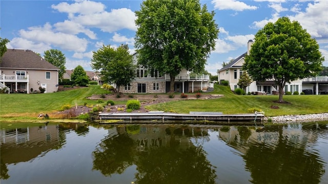 11311 E Thistlewood Ln, Effingham, IL 62401 - rear view of house featuring a water view, a lawn, and a residential view