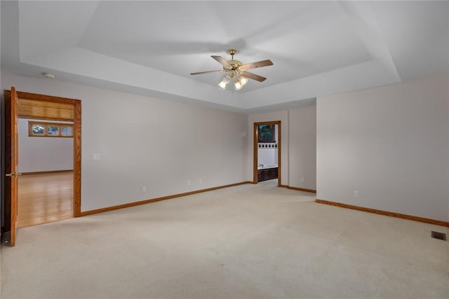 11311 E Thistlewood Ln, Effingham, IL 62401 - spare room featuring a raised ceiling, carpet, and ceiling fan