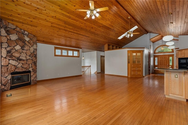 11311 E Thistlewood Ln, Effingham, IL 62401 - unfurnished living room with a ceiling fan, high vaulted ceiling, a fireplace, light wood-style flooring, and a wooden ceiling with exposed beams