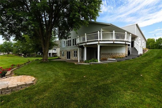 11311 E Thistlewood Ln, Effingham, IL 62401 - back of property with stone siding, a wooden deck, and a lawn