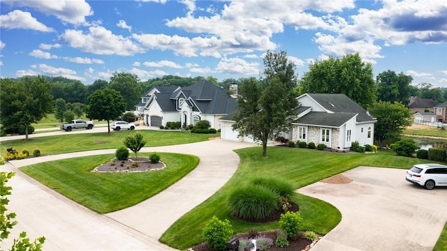 11311 E Thistlewood Ln, Effingham, IL 62401 - view of home's community with curved driveway, a lawn, and a garage