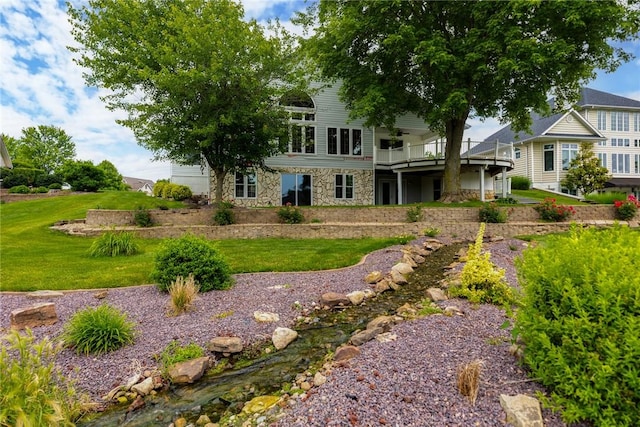 11311 E Thistlewood Ln, Effingham, IL 62401 - back of property with stone siding, a lawn, and a deck