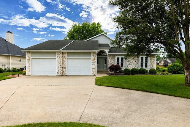 11311 E Thistlewood Ln, Effingham, IL 62401 - view of front of house featuring stone siding, concrete driveway, an attached garage, and a front lawn