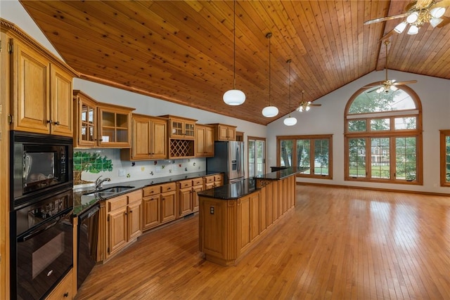 11311 E Thistlewood Ln, Effingham, IL 62401 - kitchen featuring black appliances, a ceiling fan, light wood finished floors, brown cabinets, and a center island