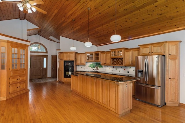 11311 E Thistlewood Ln, Effingham, IL 62401 - kitchen with stainless steel fridge with ice dispenser, black microwave, light wood-style flooring, a ceiling fan, and a center island