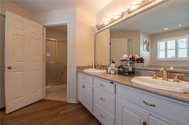 1117 Wedgewood Ct, Decatur, IL 62526 - bathroom with double vanity, a shower stall, wood finished floors, and recessed lighting