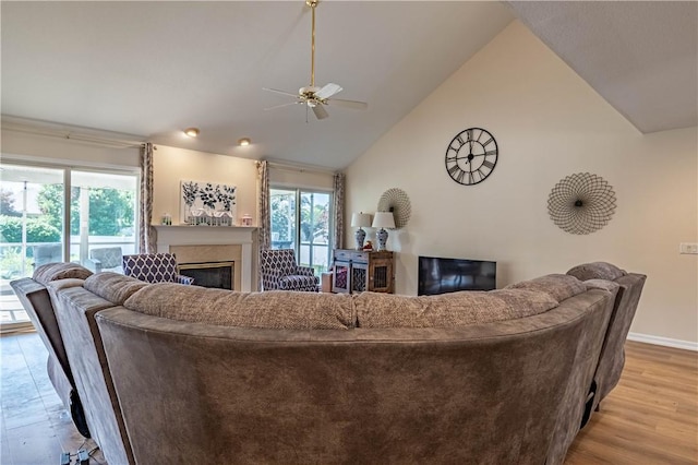 1117 Wedgewood Ct, Decatur, IL 62526 - living area with ceiling fan, a glass covered fireplace, lofted ceiling, and light wood finished floors