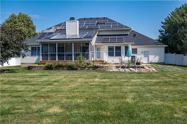 1117 Wedgewood Ct, Decatur, IL 62526 - rear view of property with a sunroom, roof mounted solar panels, a chimney, and a shingled roof