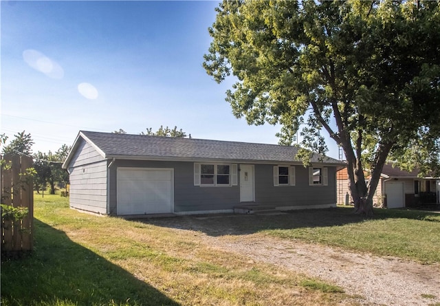 single story home featuring a front lawn and a garage