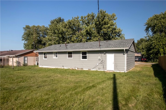 rear view of house with a yard