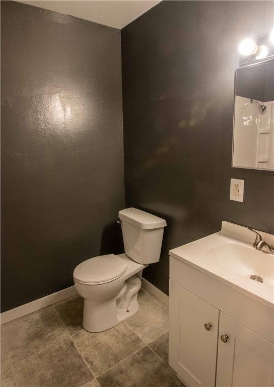 bathroom with tile patterned floors, vanity, and toilet