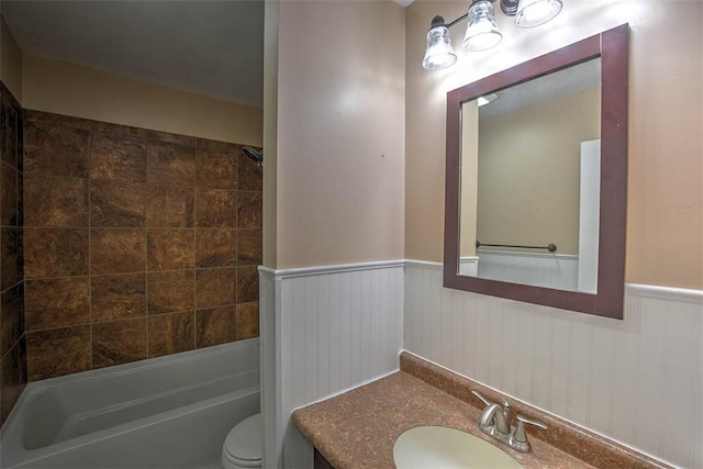 full bathroom with tiled shower / bath combo, vanity, and toilet