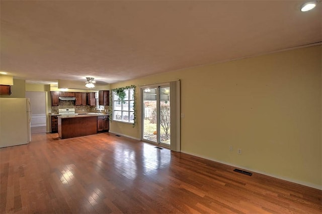 unfurnished living room with hardwood / wood-style flooring