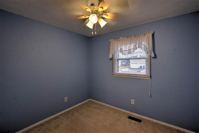 empty room with ceiling fan and carpet