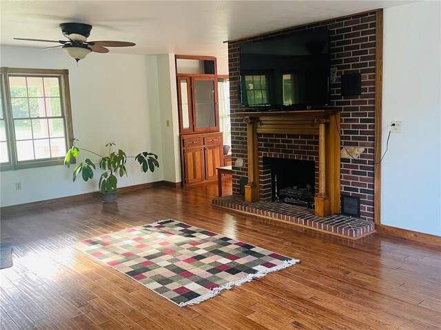 living room featuring a brick fireplace, ceiling fan, and hardwood / wood-style flooring