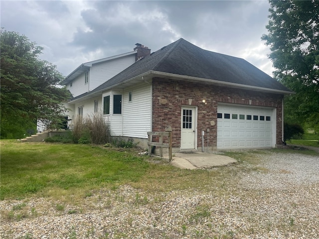 view of home's exterior featuring a yard and a garage