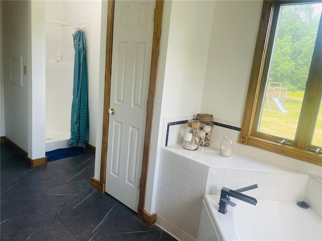 bathroom with plenty of natural light and plus walk in shower