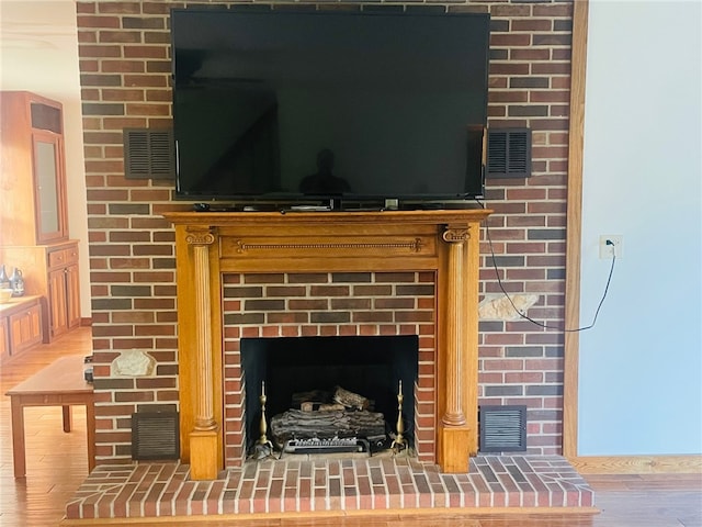 details featuring wood-type flooring and a brick fireplace