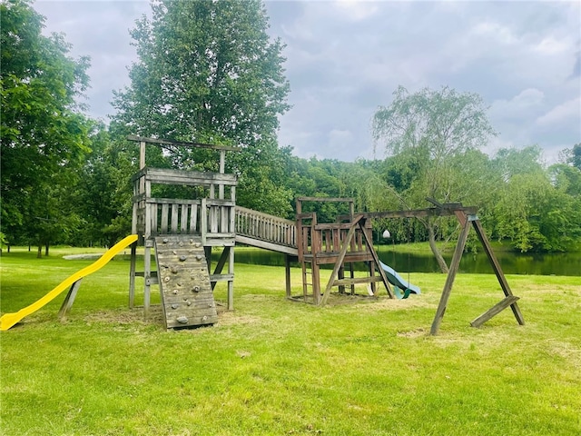 view of play area featuring a yard and a water view